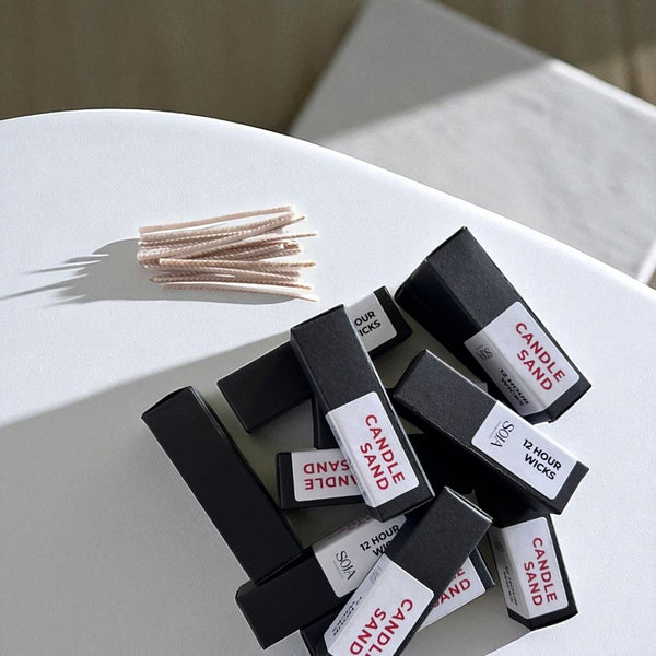 15-pack of candle wicks for use with Candle Sand, shown in a flat lay.