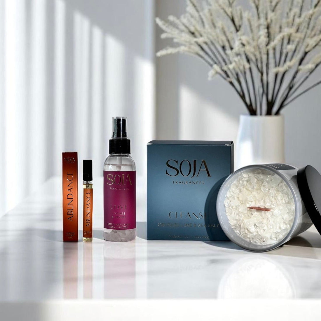 Crystal-infused soy candle lit in a calm home setting – Soja Fragrances