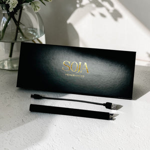 SOJA Fragrances packaging with a black rechargeable on a light surface.