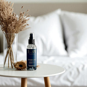 SOJA Energist room spray on a table with dried plants in the background