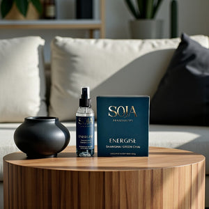 SOJA product packaging on a wooden table with a blurred living room background