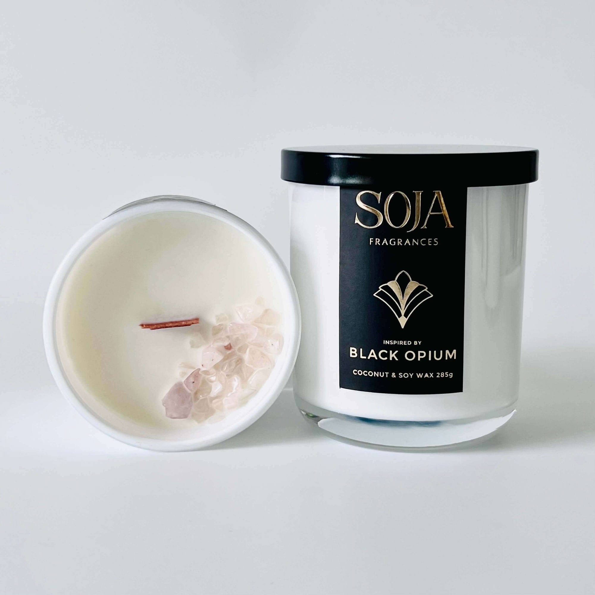Black opium perfumed candle product photo showing rose quartz crystals