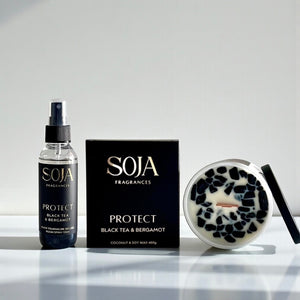SOJA Fragrances product set including a bottle, packaging, and candle on a white surface.