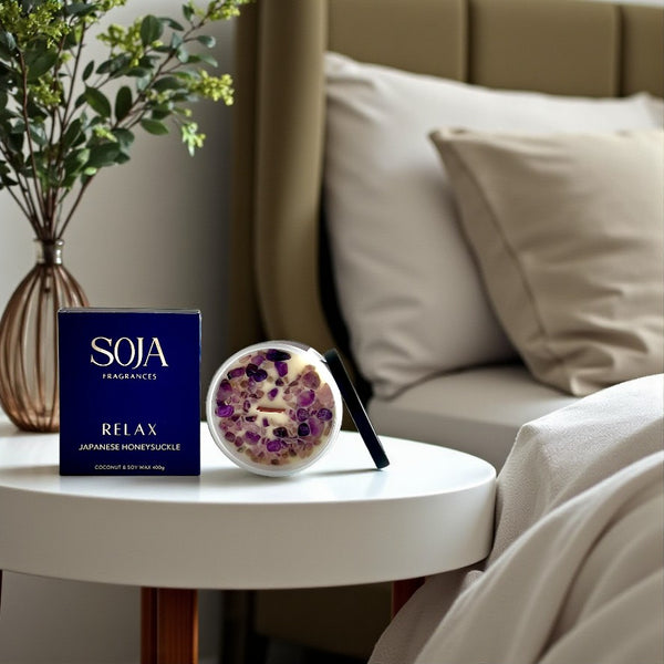 Relax Japanese Honeysuckle candle styled on bedside table with neutral decor