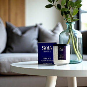 Relax crystal candle and deep purple box styled on round coffee table