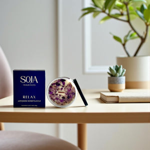 Relax crystal candle in white jar styled on console table with plant