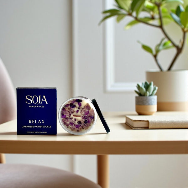 Relax crystal candle in white jar styled on console table with plant