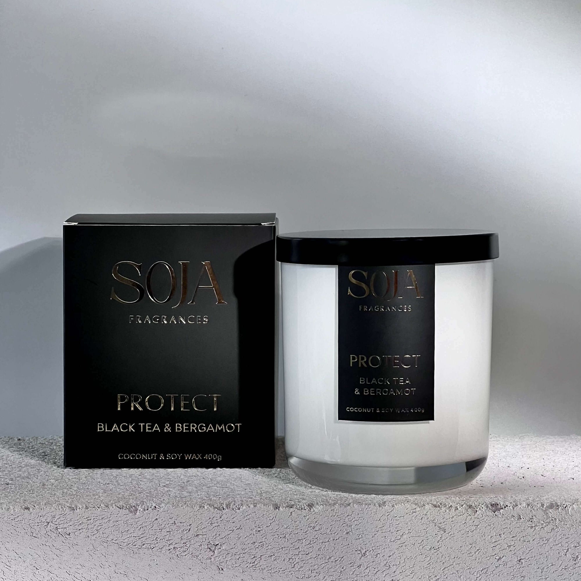 Protect black tourmaline crystals black tea & Bergamot perfumed candle next to candle box